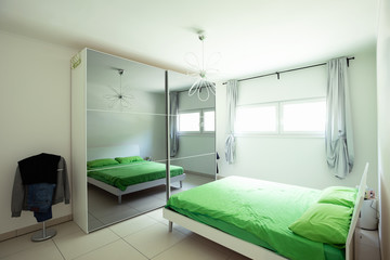 Room with double bed and green blanket