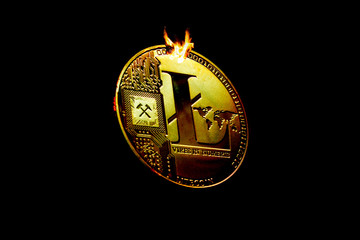 Gold crypto currency coins of litecoin in open fire