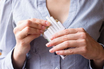Cigarette addiction. Tobacco nicotine smoke. Shallow depth of field.