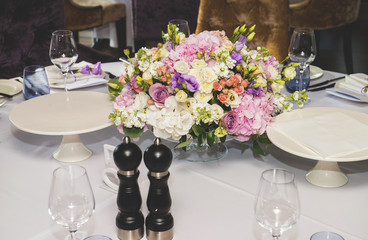 Table layout at restaurant with a bouquet of flowers