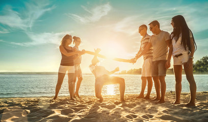 Happiness Friends funny game on the beach under sunset sunlight