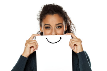 Happy young african woman with smile, drawn on sheet of paper on white background