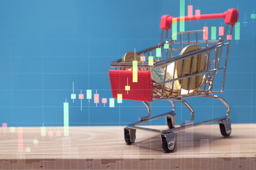double exposure financial graph and bitcoins in basket of model shopping cart on green background for virtual money, blockchain technology and cryptocurrency concept