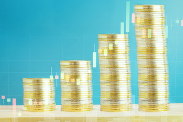 stack of golden coins on wooden and blue background with double exposure financial graph for cryptocurrency and blockchain concept