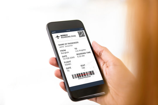 Passenger looking at electronic boarding pass on smartphone screen - Powered by Adobe