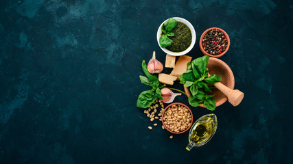 Traditional basil pesto sauce. Basil, parmesan cheese, olive oil, pine nuts, pepper, garlic. Top view. On the stone table. Free space for text.