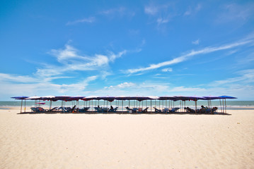 Fototapeta na wymiar Beach chairs and umbrella on the beach