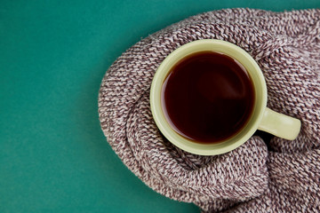 Knitted scarf with warm  cup of tea