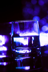 colored lighting of glasses in the night club bar