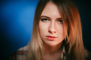 Fototapeta premium portrait smiling girl on blue background in studio