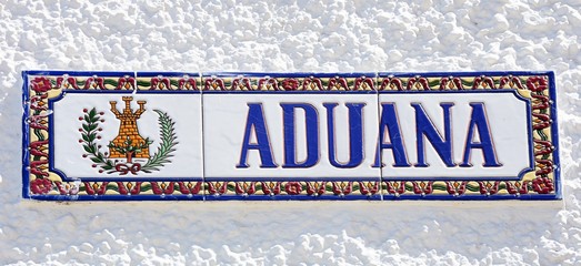 Ceramic customs (Aduana) sign on a building along the waterfront, Ayamonte, Spain.