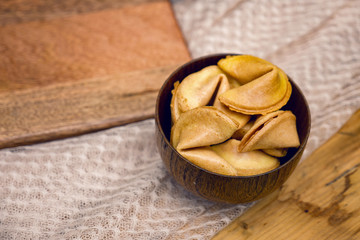 fresh cookies with a prediction lying on a wooden