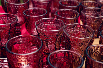 group of glasses of red glass for drinks
