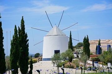 Traditional whitewashed windmill at the top of the hill, Castro Marim, Algarve, Portugal. © arenaphotouk
