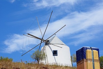 Traditional whitewashed windmill at the top of the hill, Castro Marim, Algarve, Portugal. © arenaphotouk