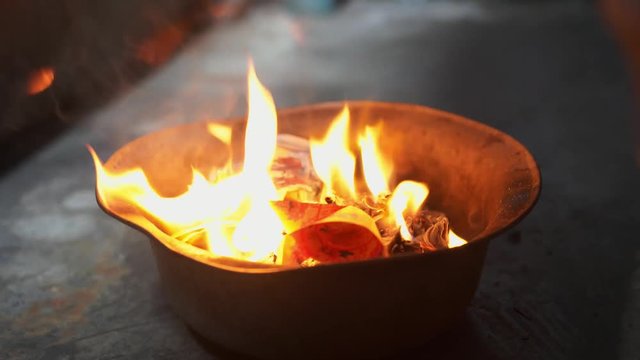 Ghost or spirit festival burning of joss paper in metal bowl