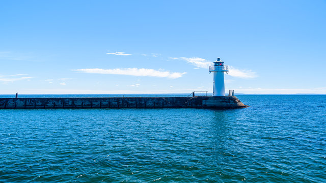 The southern lighthouse at the end of a stone pier in Hjo, Sweden. Lake Vattern is the second largest freshwater lake in Sweden.