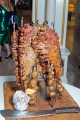 Many Cooking Traditional Turkish roasting lamb barbecues.Roasted meat over an open fire, cooked in...