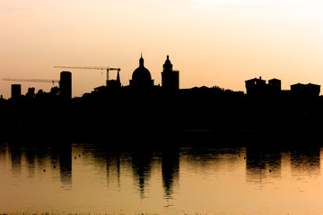 Fototapeta na wymiar Silhouette of city skyline, evening light