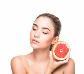 Beautiful portrait of young woman with grapefruit. Healthy food concept. Skin care and beauty.