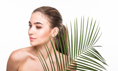 Fototapeta premium Beautiful young woman with palm leaves on white background. Skin care concept.