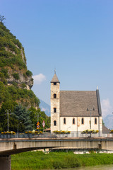 Fototapeta premium Church of St Apollinare and San Lorenzo bridge in Trento, Italy