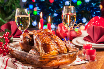 Baked or roasted whole chicken on Christmas table