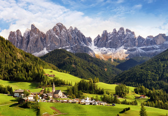 Val di Funes, Trentino Alto Adige, Italy. The great autumnal colors shines under the late sun with Odle on the background and Santa Magdalena Village on the foreground.