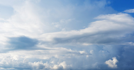Naklejka na ściany i meble Blue sky background with clouds. Close up.