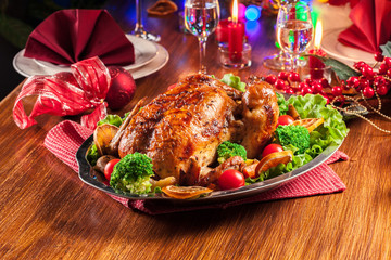 Baked or roasted whole chicken on Christmas table