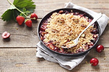 Oatmeal crumble with fresh berries and walnuts. Gluten free summer berries crisp. Selective focus