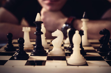 man thinking how to play chess. concept strategy for win. Want to see the chess pieces on the Board
