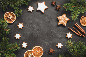 Obraz na płótnie Canvas Christmas or New Year 2019 Frame Background. Gingerbread cookies, spices, fir tree and cinnamon on concrete background. Copy space for text