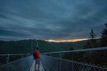 Traveler on the suspension bridge in Germany. Geierlay, Morsdorf.