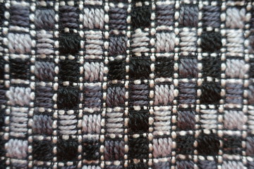 Embroidered grey fabric with geometric pattern from above