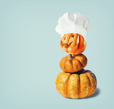 Funny Pumpkin Jack With Chef Hat On Light Blue Background With Copy Space, Top View. Halloween And Thanksgiving  Cooking Concept