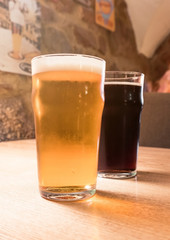Glass of cold craft stout beer on the old table 