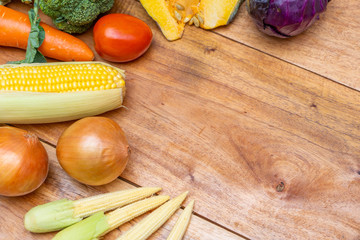 Variety of raw organic vegetables on wooden table