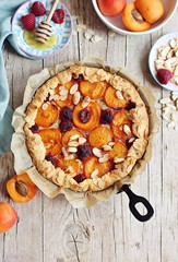 Tart with apricots and raspberry. Summer berries dessert. Overhead view.