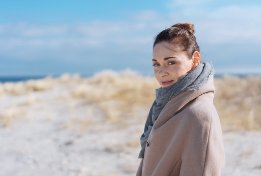 Attractive woman on a sunny sandy winter beach