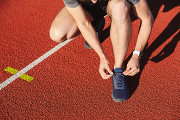 Close up of a young sportsman tying shoelaces