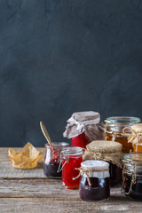 Assortment of seasonal berries and fruits jams in jars