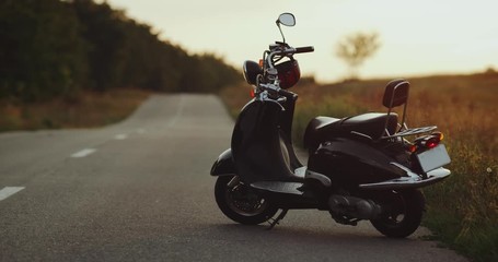 Amazing retro balck motorbike standing in the middle of the road, focusing on the bike , amazing sky.