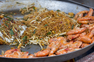 Pad Thai or Fried Rice Sticks with Shrimp in the big pan, Traditional thai food.
