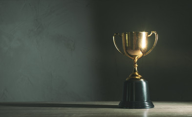 champion golden trophy placed on wooden table - obrazy, fototapety, plakaty