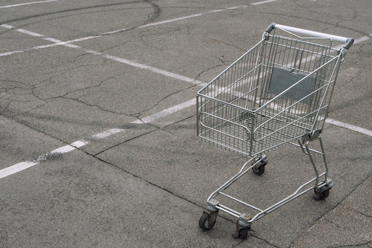 shopping cart without products goods empty on parking slot