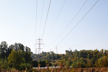High-voltage lines. Electric line among nature