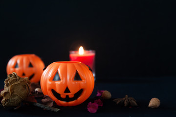 Halloween pumpkins and candle with black background and copy space