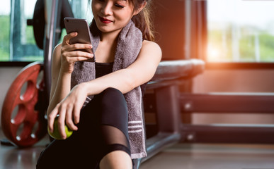 Young woman girl sitting lifestyle using smartphone after training exercise workout