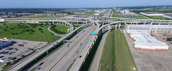 Panorama top view Interstate 10 or Katy freeway massive intersection, stack interchange, elevated road junction overpass in daytime with clear blue sky. Aerial metropolitan area of Katy, Texas, US - obrazy, fototapety, plakaty